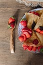 Breakfast of a plate of pancakes with strawberries, top view