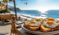 A breakfast plate of toast and fried eggs on a table by the sea Royalty Free Stock Photo