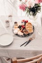 Breakfast platter. Table setting. Pancakes, breakfast sausages, berries, fruits, chocolate spread and coffee. Morning light. White Royalty Free Stock Photo