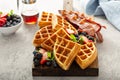 Breakfast platter with waffles, berries and bacon Royalty Free Stock Photo