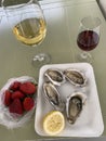 Breakfast at the Portuguese market, consisting of oysters, wine, port wine, strawberries.