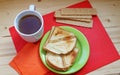 Breakfast on a red and wooden background.