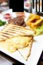 Breakfast sandwich with scrambled egg closeup - image. Blurred food background