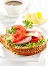 Breakfast sandwich with sliced sausage and tomato Royalty Free Stock Photo