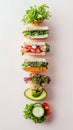 A breakfast sandwich stack showcases an array of fresh vegetables layered between slices of whole grain bread, arranged Royalty Free Stock Photo