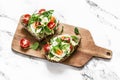 Breakfast sandwiches with multigrain bread, avocado, boiled egg, microgreens, cherry tomatoes and homemade mayonnaise sauce on a Royalty Free Stock Photo