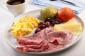 Breakfast with sausages, scrambled eggs, cheese, olives, coffee, and buns Royalty Free Stock Photo