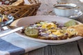 Breakfast with Scrambled eggs, bacon, pickles,toasted bread, butter nad coffee. Royalty Free Stock Photo