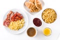 Breakfast with scrambled eggs, bacon, tomatoes,coffee,orange juice ,croissant and corn flakes isolated Royalty Free Stock Photo