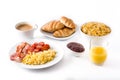 Breakfast with scrambled eggs, bacon, tomatoes,coffee,orange juice ,croissant and corn flakes isolated Royalty Free Stock Photo