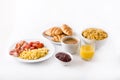 Breakfast with scrambled eggs, bacon, tomatoes,coffee,orange juice ,croissant and corn flakes isolated Royalty Free Stock Photo