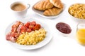 Breakfast with scrambled eggs, bacon, tomatoes,coffee,orange juice ,croissant and corn flakes isolated Royalty Free Stock Photo