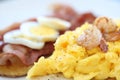 Breakfast with scrambled eggs, fried potatoes bacon and shrimp Royalty Free Stock Photo