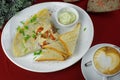 Breakfast with scrambled eggs, with tomato, coffee and toast.