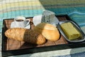 Breakfast served in bed being illuminated by the rays of the sun. Breads, blue cheese, baguette, butter and black coffee side Royalty Free Stock Photo