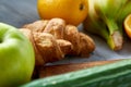Breakfast served with croissants and fruits, top view, close-up, selective focus Royalty Free Stock Photo