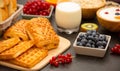 Breakfast Served in the morning with Butter bread and corn flakes Whole grains and raisins with milk in cups and Strawberry, Blueb Royalty Free Stock Photo