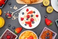 Breakfast Served in the morning with Butter croissant and corn flakes Whole grains and raisins with milk in cups and Strawberry,