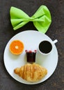 Breakfast serving funny face on the plate (jam, croissant, orange) Royalty Free Stock Photo