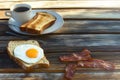 Breakfast set with bacon, eggs, toast, coffee, and clean space above for text or logo Royalty Free Stock Photo