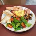 Breakfast set, comprised of omelette, sausages, bread, grilled mushroom and rocket salad Royalty Free Stock Photo