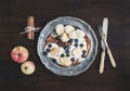 Breakfast set on dark wooden desk: apple and cinnamon pancakes