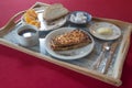 Breakfast set on a decorated tray with cake, coffee, bread, butter and orange Royalty Free Stock Photo