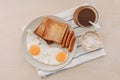Breakfast set of fried eggs toasted bread sausages and tuna spread. Royalty Free Stock Photo