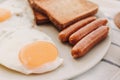 Breakfast set of fried eggs toasted bread sausages and tuna spread Royalty Free Stock Photo