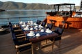 A big table and breakfast setting in the morning in a luxury, classical, wooden yacht in Aegean Sea.