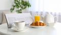 Breakfast setup with newspaper coffee and croissant Royalty Free Stock Photo