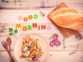 Breakfast setup on wooden table with colourful Good Morning wor Royalty Free Stock Photo