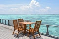 Breakfast setup with wooden tables and chairs at the restaurant near the ocean Royalty Free Stock Photo