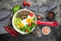 Breakfast skillet pan of fried egg, avocado and mushrooms. Ketogenic diet. Low carb high fat breakfast. Healthy food concept. Royalty Free Stock Photo