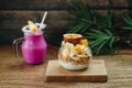 Breakfast Smoothie and Muesli with yoghurt and tropical fruit at brown background Royalty Free Stock Photo