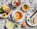 Breakfast or snack table. Lemon tea, fresh fruit, yogurt with granola, blue cheese, biscuits. Royalty Free Stock Photo