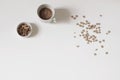 Breakfast still life. Crispy honey oat or buckwheat heart shaped cereals isolated on white table background. Cup of Royalty Free Stock Photo