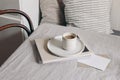 Breakfast still life scene. Cup of coffee, magazine and greeting card mockup on beige linen tablecloth. Scandinavian Royalty Free Stock Photo