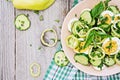 Salad of eggs and cucumbers with green onions and basil.