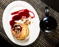 Breakfast with sweet pancakes topped blueberry jam, teapot with fruit tea