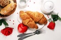 Breakfast on table with bread buns, croissants, coffe and juice on valentines day Royalty Free Stock Photo