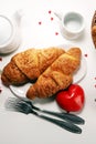 Breakfast on table with bread buns, croissants, coffe and juice on valentines day Royalty Free Stock Photo