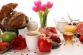 Breakfast on table with bread buns, croissants, coffe and juice on valentines day Royalty Free Stock Photo