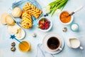 Breakfast table. Coffee, eggs, buns, juice and jam. Blue background, top view, food flat lay Royalty Free Stock Photo