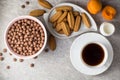 Breakfast table with coffee, ginger cookies, chocolate cereal balls, milk, and apricots on stone background. Royalty Free Stock Photo