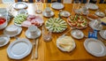 Breakfast table with crockery, cutlery and a large selection of food Royalty Free Stock Photo