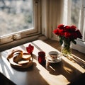 a breakfast table , a cup of coffee, a bread,red roses in a bottle - 1 Royalty Free Stock Photo