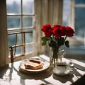 a breakfast table , a cup of coffee, a bread,red roses in a bottle - 1 Royalty Free Stock Photo