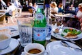 Breakfast Table With Eaten Food And Bottles Of Water With Empty Coffee Cups