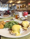 breakfast table with egg Benedict plate Royalty Free Stock Photo